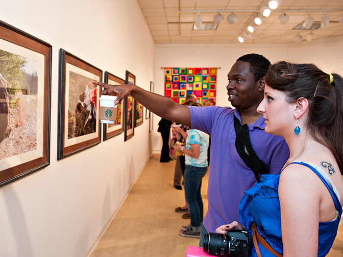 Students viewing an exhibit at the Daura Gallery