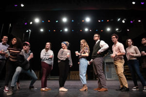 Students dance on a stage.