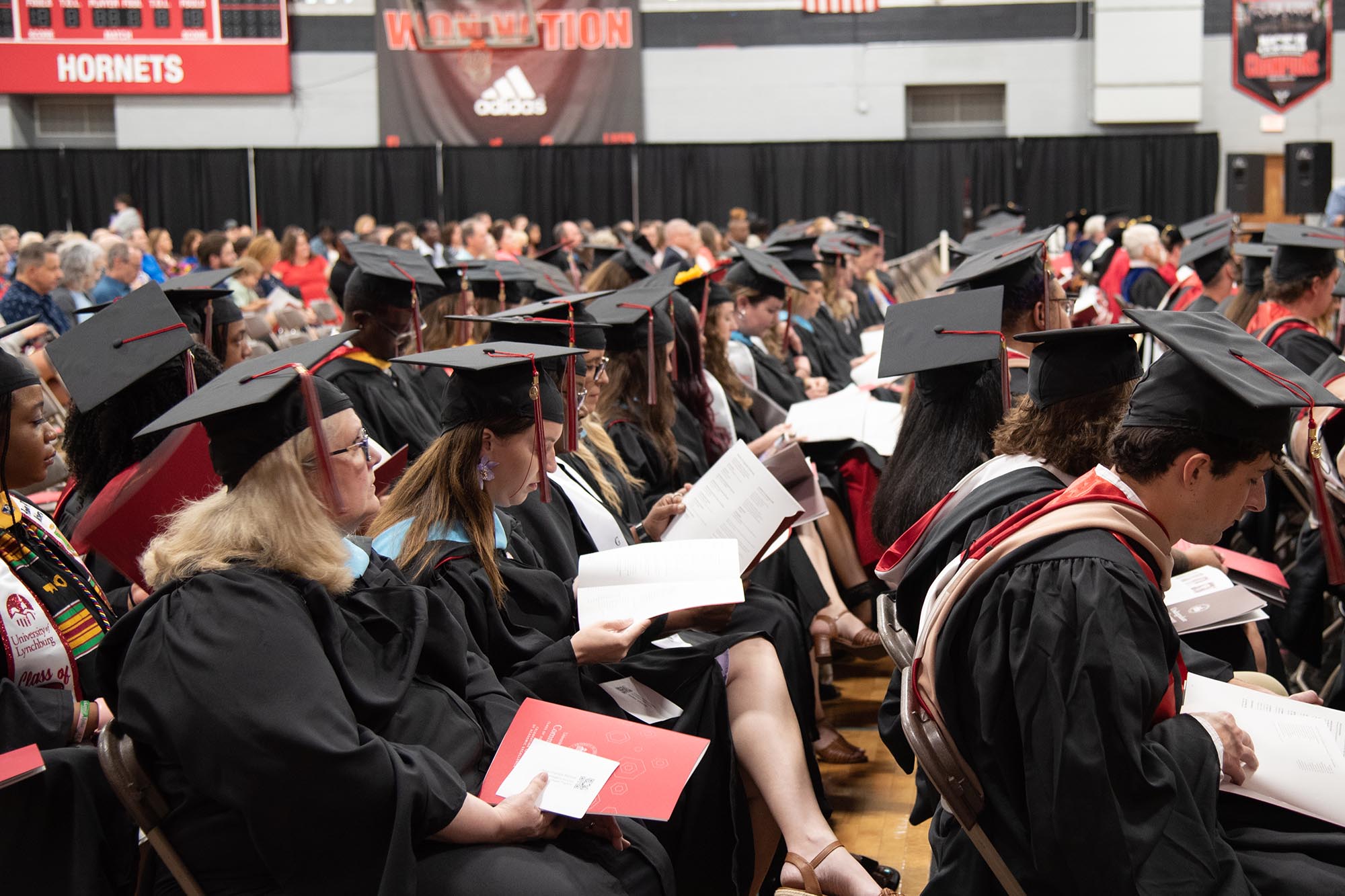 Master's candidates sitting at their graduation.