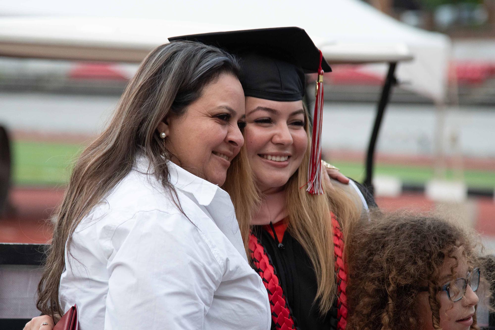 A graduate posing with family.