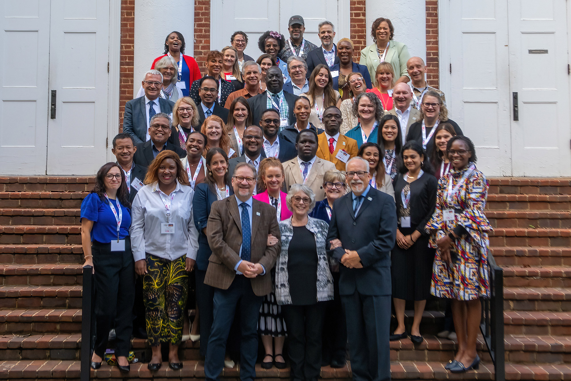 The attendees of the 15th annual IAPAE conference stand for a group photo on the steps of Hall Campus Center