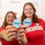 Two UL staffers holding "I Gave" buttons.