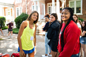 Multiple students smiling at student orientation and registration.