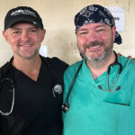 Dr. Kaufman and Dr. Gray wearing scrubs and smiling.