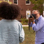 John McCormick takes a photo of a student on the Dell